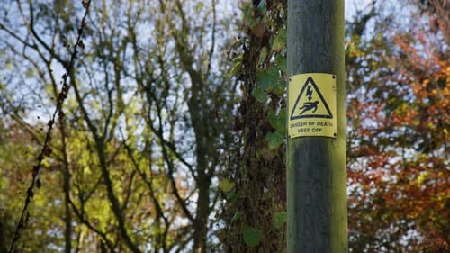 Danger Of Death Keep Out Safety Sign On The Street Near Autumn Park.