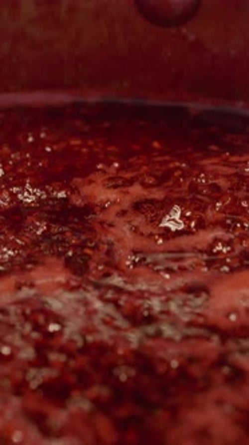 Close-up of Bubbling Red Fruit Jam in Pot