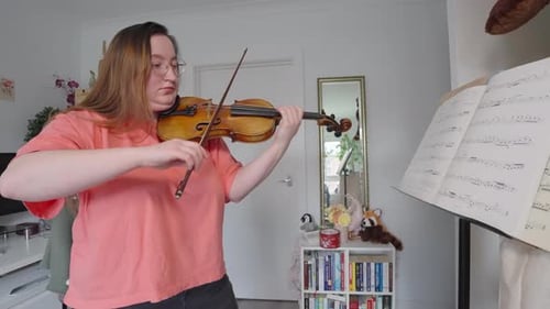 Woman Plays Violin at Home