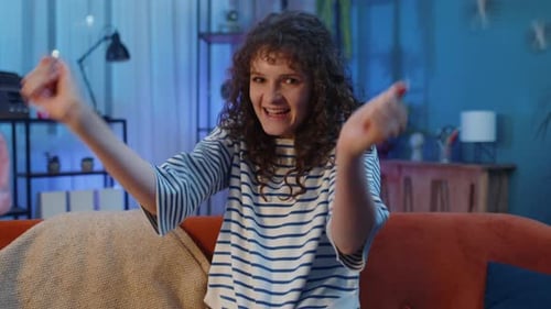 Woman With Curly Hair Dances and Smiles