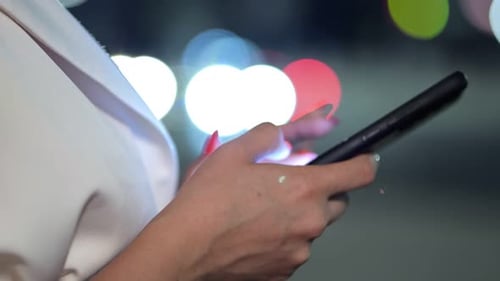 Businesswoman Types Messages to Friend on Smartphone