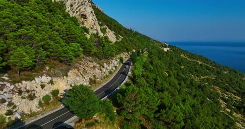 Drone shot of cars on road 8 on the coast of the Makarska riviera in Croatia