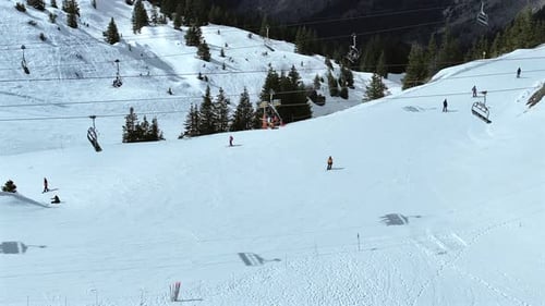 Skiers and Snowboarders Using a Chairlift To Ascend a Mountain