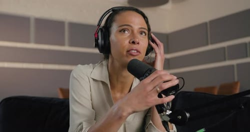 Young Adult Female Podcaster in Studio Recording Podcast, Wearing Headphones