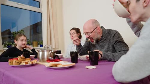 Family Mealtime Around the Dinner Table at Home