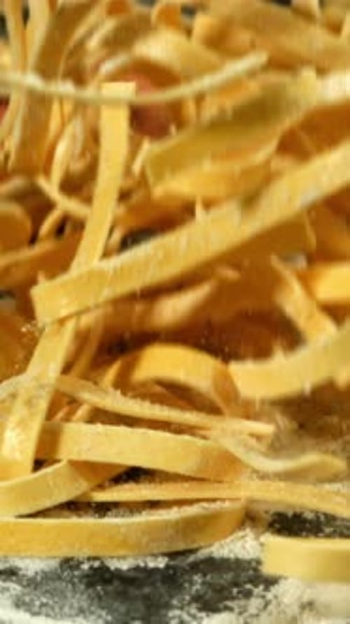 Pasta Falls on a Board with Flour View From Above Filmed on a Highspeed Camera at 1000 Fps