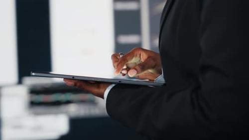 Close Up of Businesswoman Using Tablet to Compare Company KPIs Data