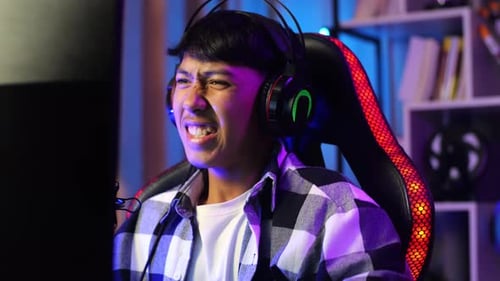 Asian Boy Streamer Celebrating Winning Game On Computer. Live Stream Video Game