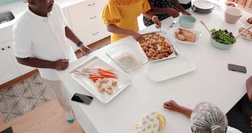 Overhead view of group preparing food in kitchen