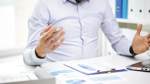 Professional Man Analyzing Charts at Office Workplace