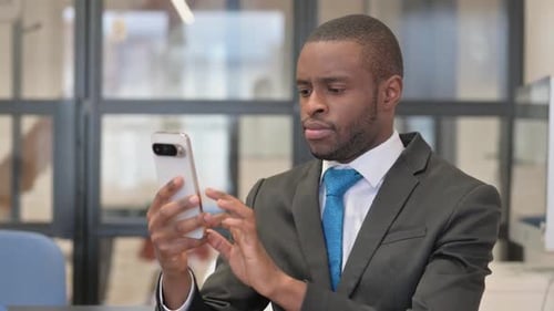 Young Adult Using Smartphone in Corporate Office Setting