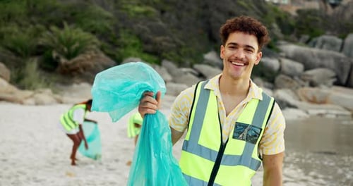 Young Adult Volunteers Cleaning Garbage From Sandy Beach