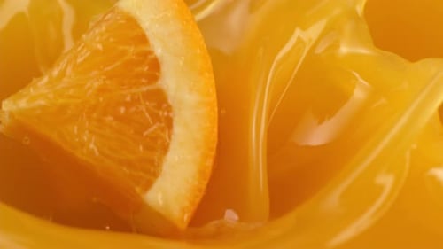 Orange Juice Splash with Citrus Wedges in Liquid