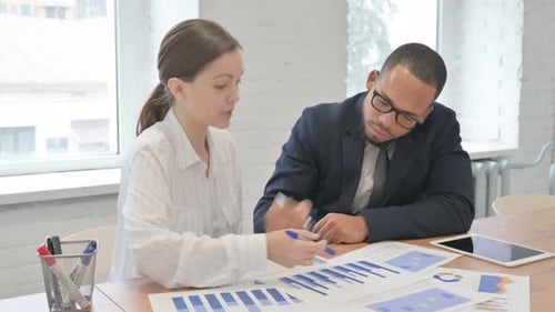 Mixed Race Business People Doing Paperwork in Office