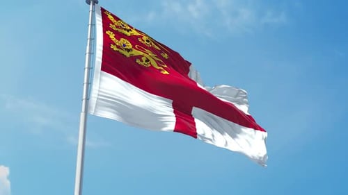 Guernsey Flag Waving Realistically in Blue Sky
