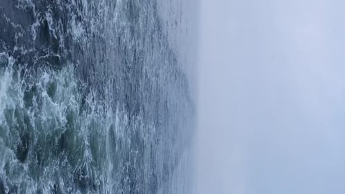 Choppy Ocean Water with Foggy Sky