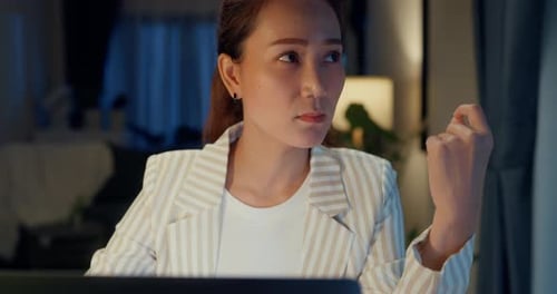 Woman Working on Computer at Night