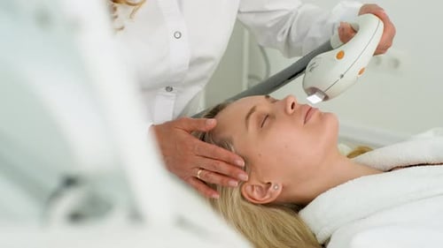 Woman receiving nonsurgical facial procedure in clinic