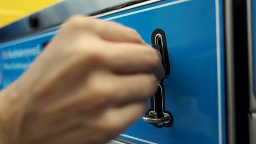 close-up woman paying for laundry with coins in the washing machine