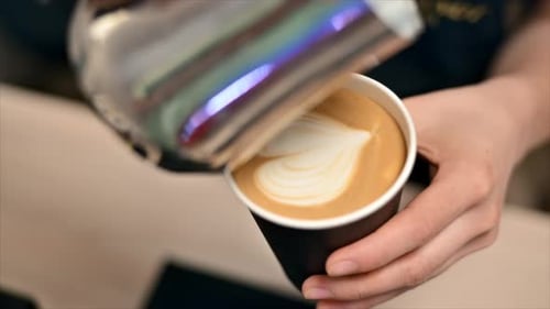 Barista Creating Heart Latte Art in Coffee Cup