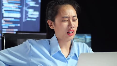 Close Up Of Asian Female Programmer Having A Backache While Writing Code By A Laptop