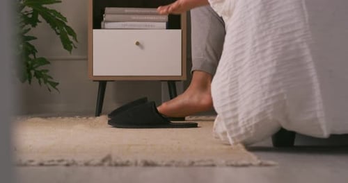 Putting On Slippers At Bedside