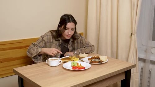 Young Woman Eating Lunch at a Table