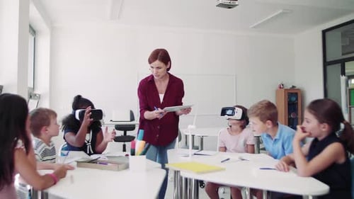 Group of Small School Kids with VR Goggles and Teacher in Class,