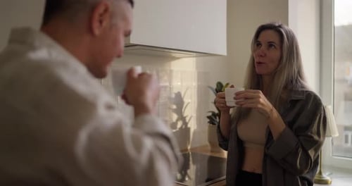 Couple Drinking Coffee Together in Kitchen