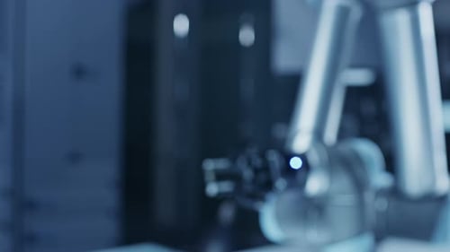 Robotic Arm Holding Computer Chip in Factory Setting