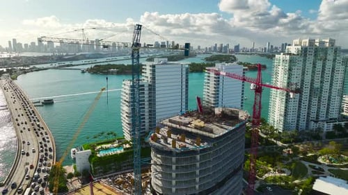 Tower Lifting Cranes at High Residential Apartment Building Construction Site