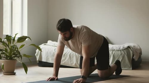 Man Doing Arm and Leg Raises on Yoga Mat