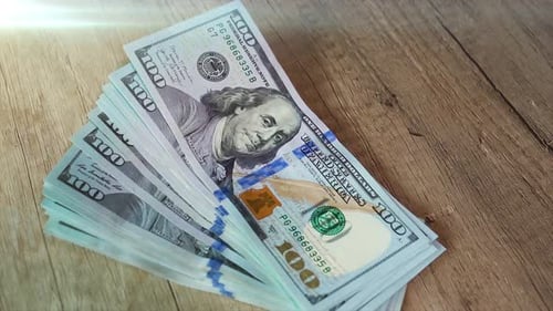 Stack of One Hundred Dollar Bills on Wood