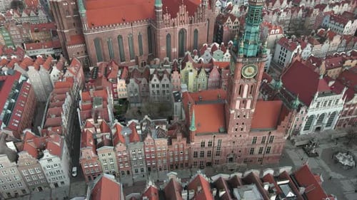 Aerial tilt up revealing Gdansk town hall and St. Mary's Church