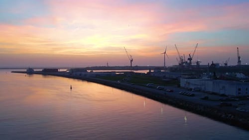 Sunset over the river near a shipyard