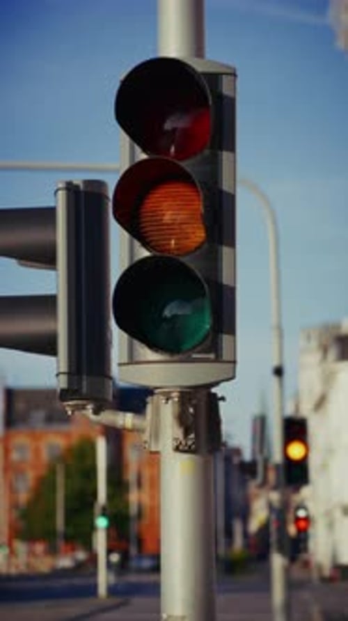 Traffic Light Switching From Green To Red In City Setting