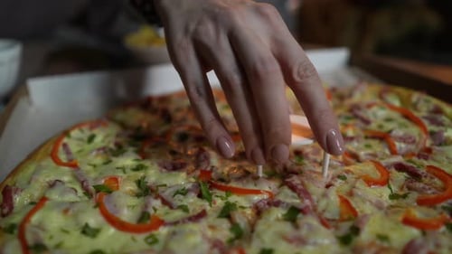 Closeup Footage of Pizza in a Box and Female Hand Taking Plastic Circle From the Middle