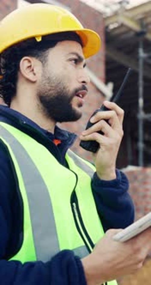 Tablet, man and radio on construction site with communication for building, renovation or repairs