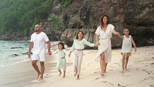 Happy Family of Adult People with Children Walking at Sea Water of Ocean Beach