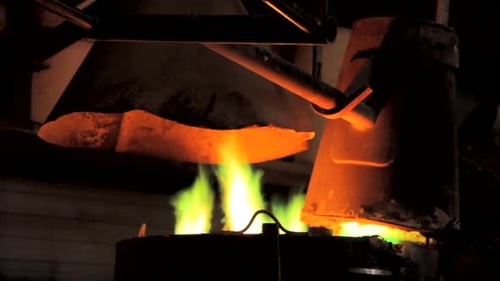 Yellow, green fire in bronze factory. Melting bronze for art craft.