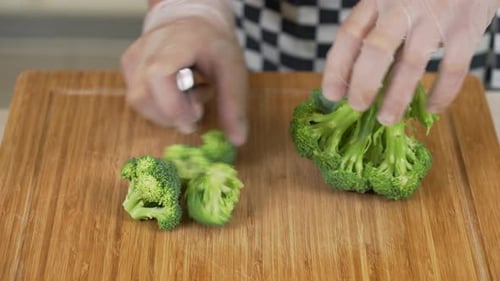 Cutting Broccoli Cabbage on a Cutting Board