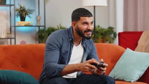 Excited Man Playing Video Games on Couch