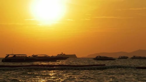 Red Sunset on the Sea with Silhouette Boats Swaying on the Waves Thailand Pattaya