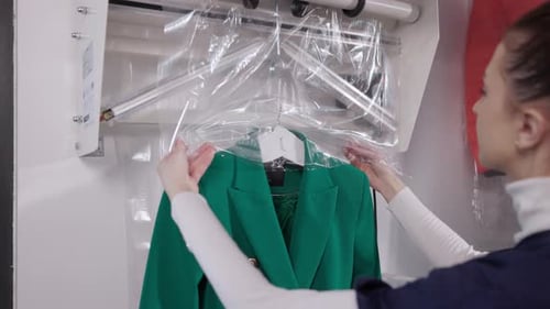 Woman Covering Green Blazer with Plastic