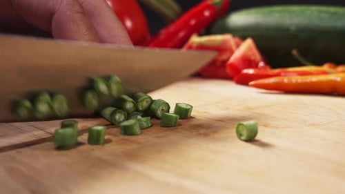 Slicing Fresh Green Beans on Wood Cutting Board
