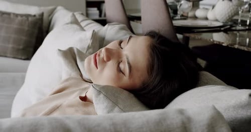 Woman Sleeping Peacefully on Couch During the Day