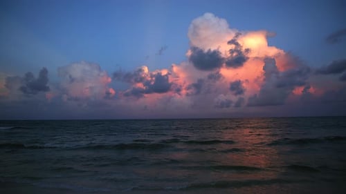 Stunning and Breathtaking Sunset Over a Tranquil Ocean with Dramatic Cloud Formation