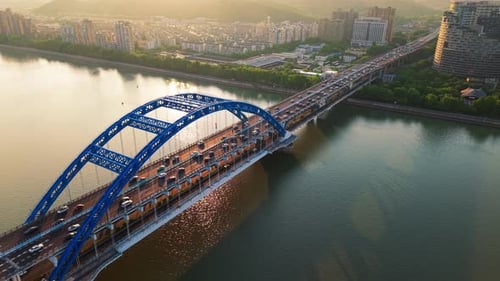 Aerial View of a Busy Bridge with Cars Crossing Over Water During Daylight