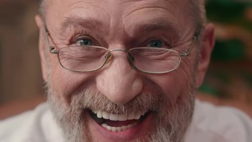 Close Up Wrinkled Face Old Aged Caucasian European Man Looking at Camera Laughing Smiling Male