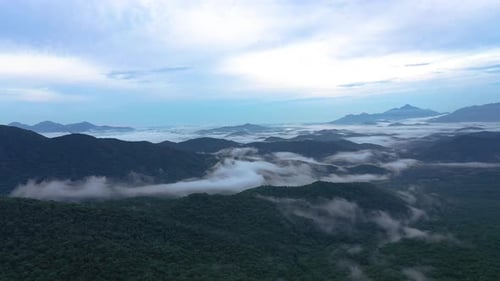 Drone panning a beautiful scenery of the high mountains on the cloud at sunrise